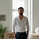Amir in a bright empty living room